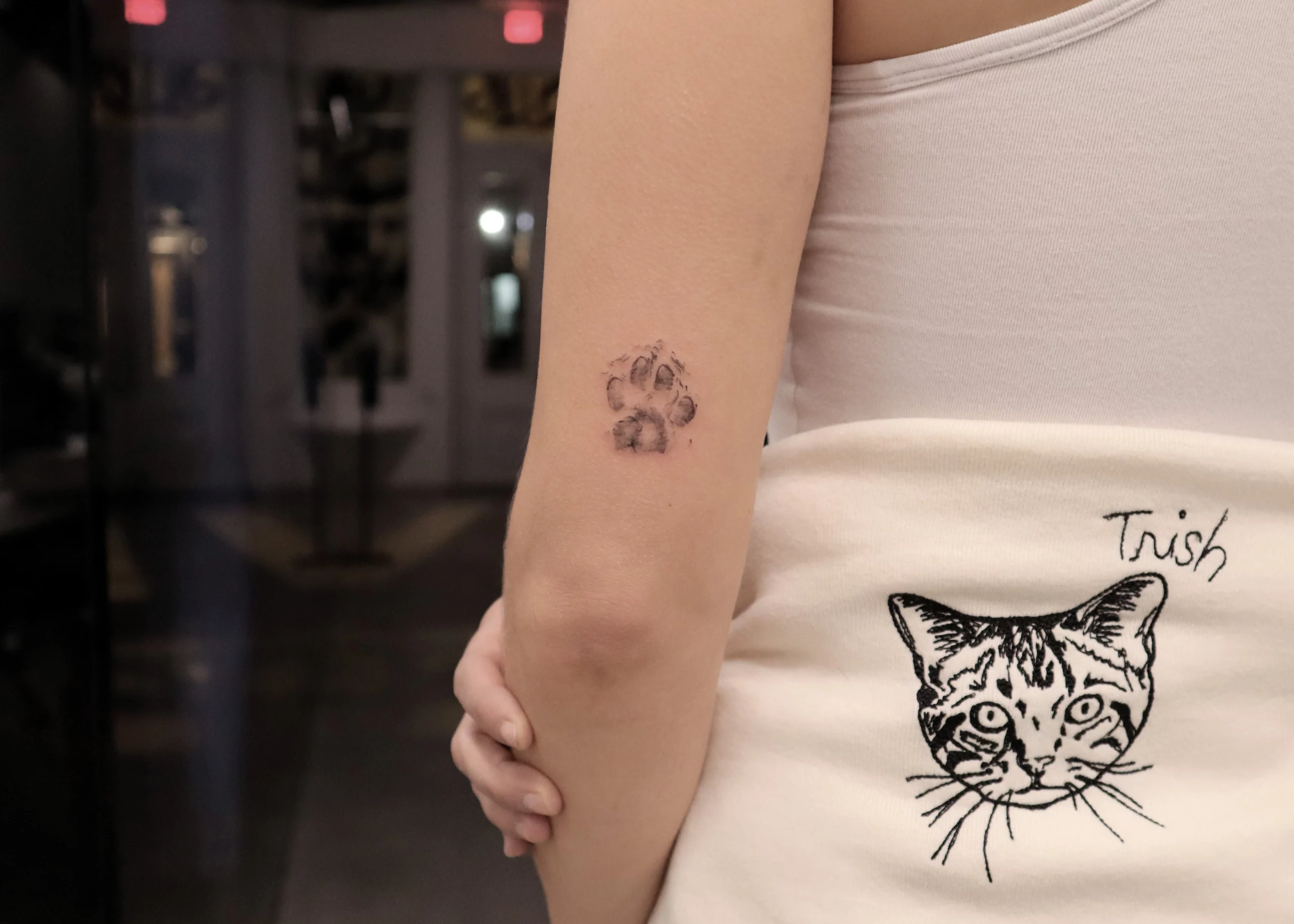 Cat And Paw Print Tattoo