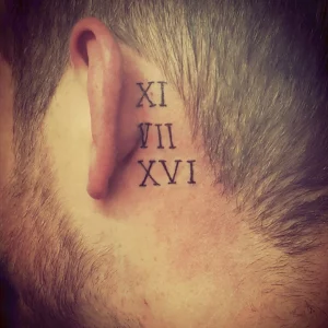 4 Roman Numeral Tattoos Behind Ear - Subtle Elegance