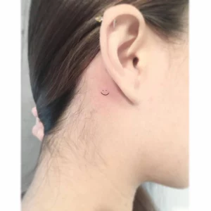 small face tattoos by ear